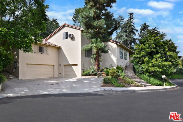 mediterranean / spanish-style home featuring a garage