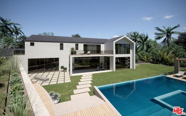 rear view of property featuring a lawn, a patio area, and a balcony