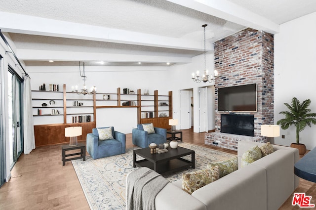 living room featuring a fireplace, beam ceiling, a textured ceiling, and an inviting chandelier