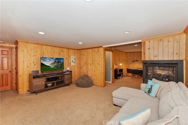 carpeted living room with crown molding and a multi sided fireplace