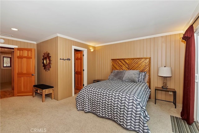 carpeted bedroom featuring wood walls and ornamental molding