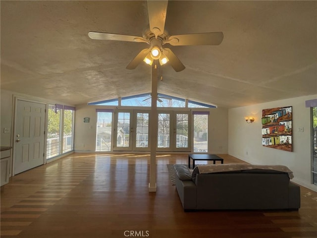 living room with vaulted ceiling, ceiling fan, and dark wood-type flooring