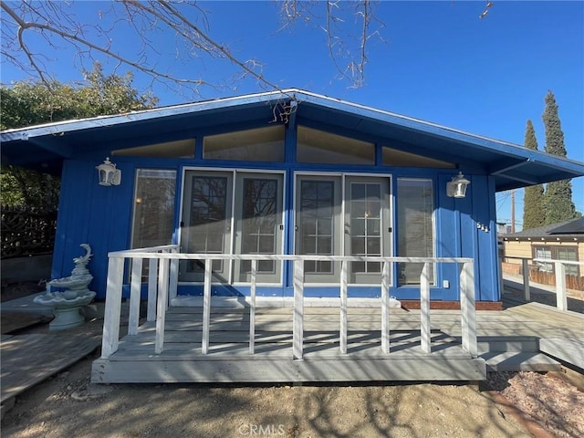 back of property with a sunroom