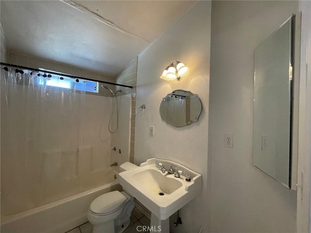 full bathroom featuring tile patterned flooring, tiled shower / bath combo, toilet, and sink