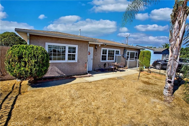 rear view of property featuring a patio area