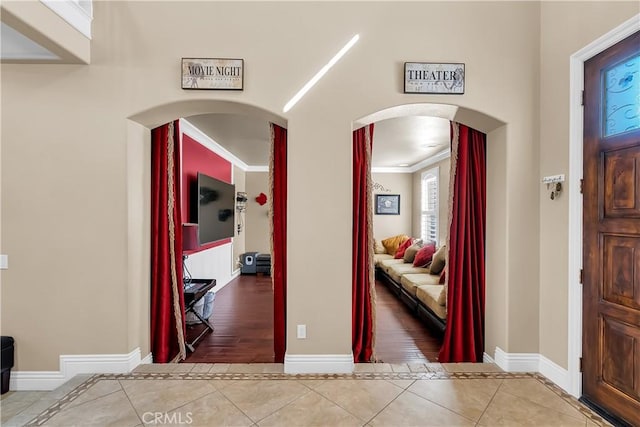 entrance foyer featuring wood-type flooring and ornamental molding