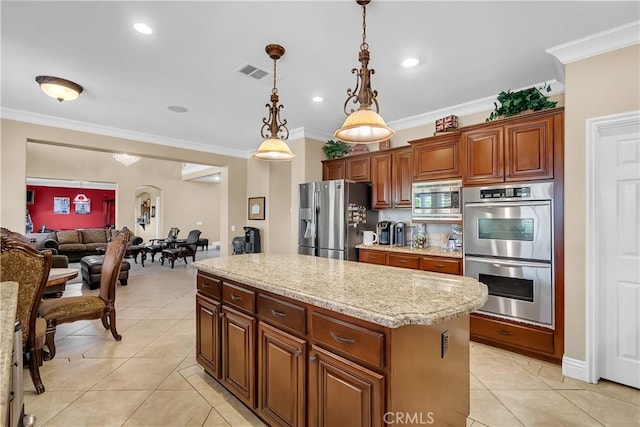 kitchen with pendant lighting, a center island, stainless steel appliances, and crown molding