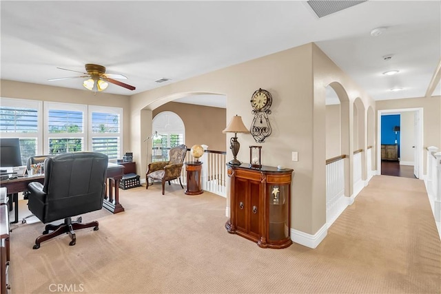 carpeted office with ceiling fan