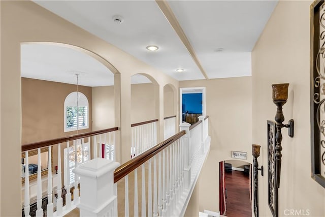 hallway featuring hardwood / wood-style floors and a notable chandelier