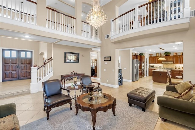 living room featuring light tile patterned floors, a high ceiling, and a notable chandelier