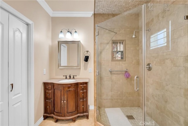 bathroom with tile patterned floors, vanity, an enclosed shower, and ornamental molding