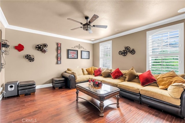 living room with hardwood / wood-style flooring, ceiling fan, and crown molding