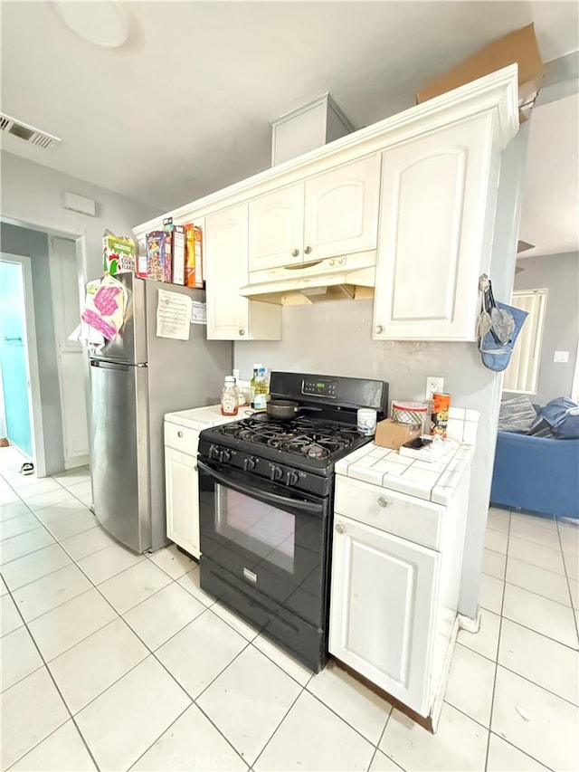 kitchen featuring tile counters, gas stove, and light tile patterned flooring