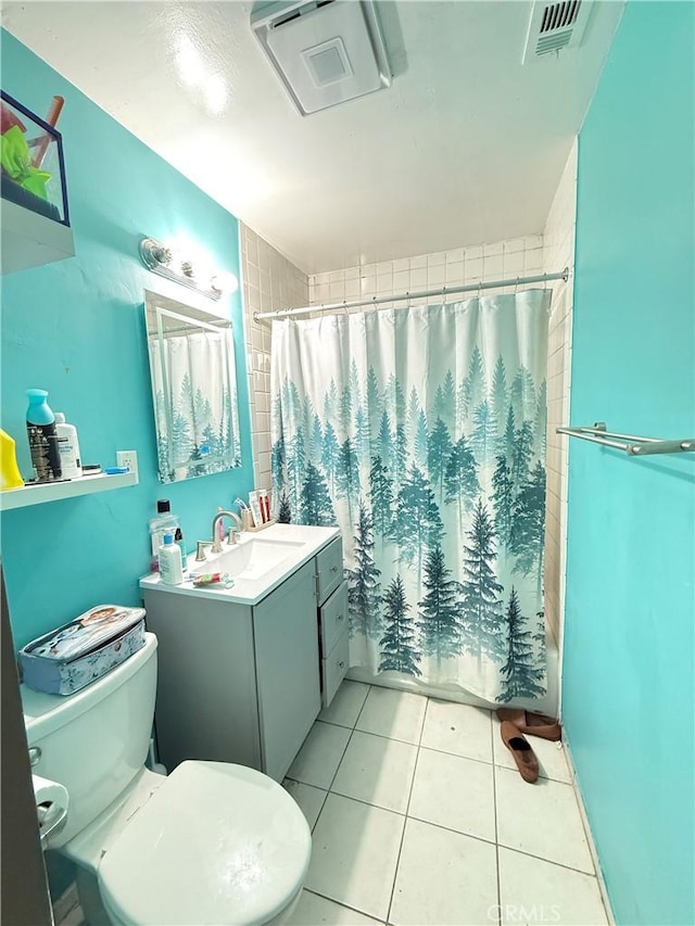 full bathroom featuring toilet, tile patterned floors, vanity, and shower / bath combo with shower curtain