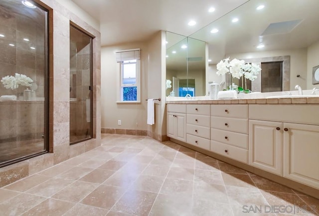 bathroom with vanity and a shower with shower door