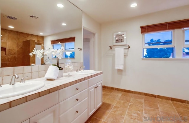 bathroom featuring vanity and decorative backsplash