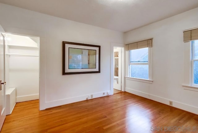 empty room with light hardwood / wood-style flooring