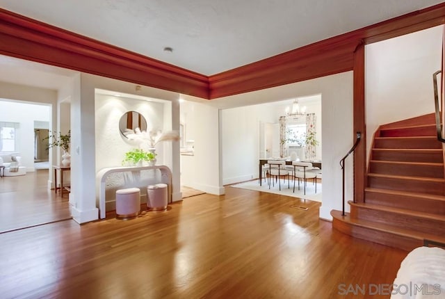 foyer with a chandelier and hardwood / wood-style flooring