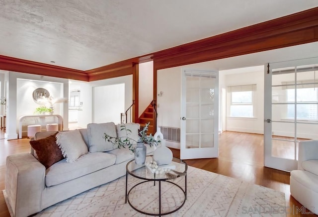 living room with french doors and light hardwood / wood-style flooring