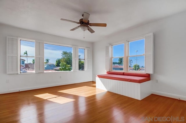 empty room with ceiling fan and hardwood / wood-style floors