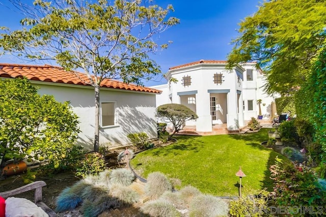 rear view of property featuring a yard