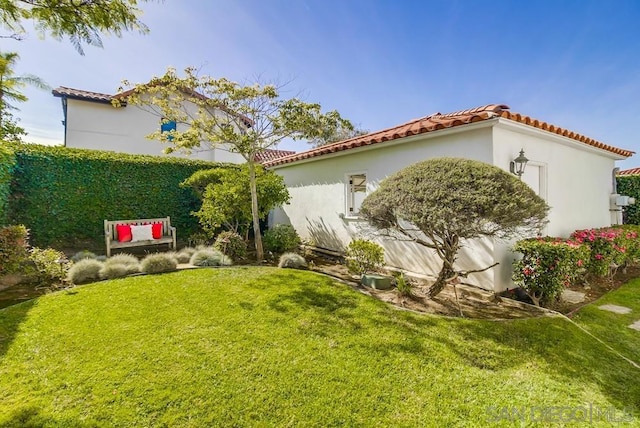 view of home's exterior with a lawn