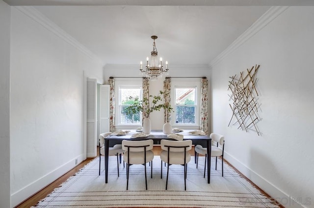 dining area with light hardwood / wood-style floors, a notable chandelier, and ornamental molding