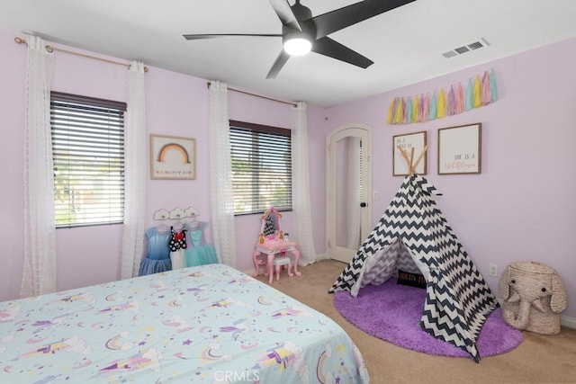 bedroom featuring ceiling fan and carpet