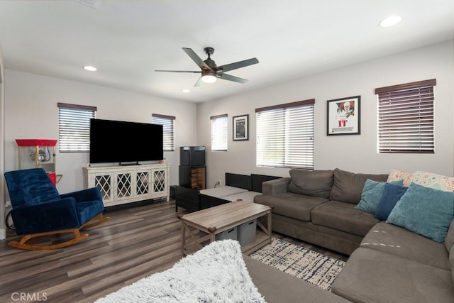 living room with ceiling fan and dark hardwood / wood-style flooring