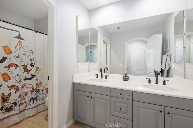 bathroom featuring tile patterned flooring, a shower with curtain, and vanity