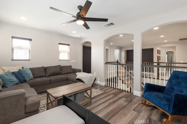 living room featuring ceiling fan and wood-type flooring