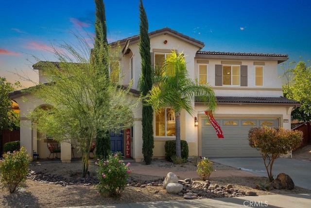 mediterranean / spanish-style home featuring a garage