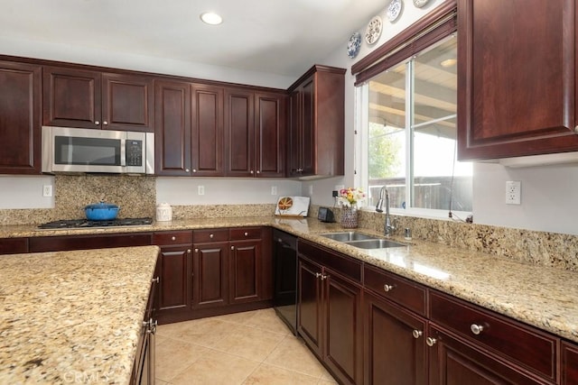 kitchen featuring light stone countertops, sink, stainless steel appliances, decorative backsplash, and light tile patterned floors