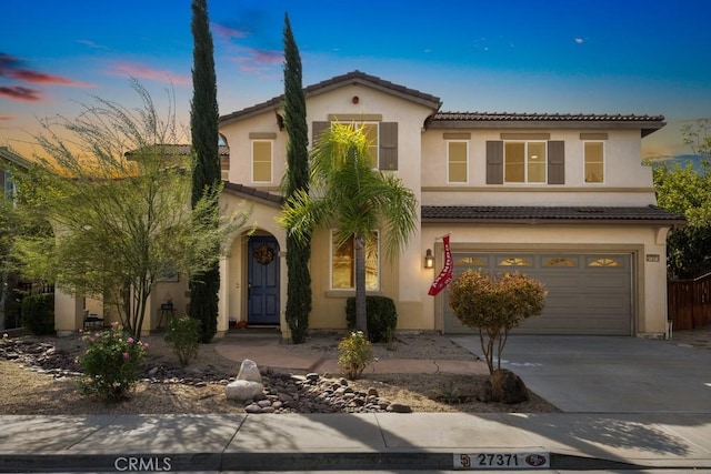 mediterranean / spanish-style house with a garage