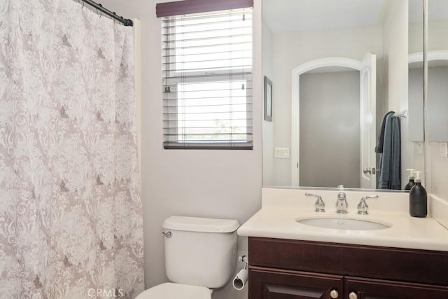 bathroom featuring vanity and toilet