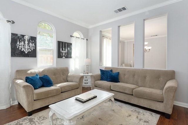 living room featuring a chandelier, wood-type flooring, and ornamental molding