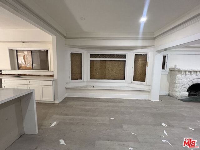 unfurnished living room featuring a fireplace and ornamental molding