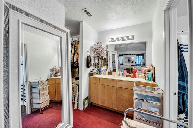 bathroom featuring vanity and a textured ceiling