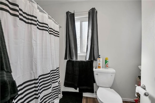 bathroom featuring hardwood / wood-style floors and toilet