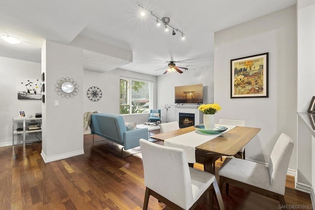 dining room featuring ceiling fan and dark wood-type flooring