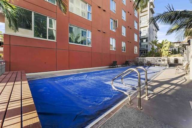 view of swimming pool with a patio area