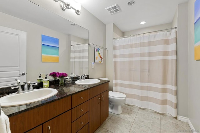 bathroom featuring tile patterned flooring, vanity, and toilet