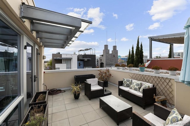 view of patio with an outdoor living space and a balcony