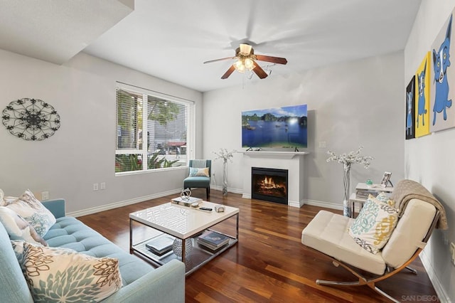 living room featuring ceiling fan and dark hardwood / wood-style floors