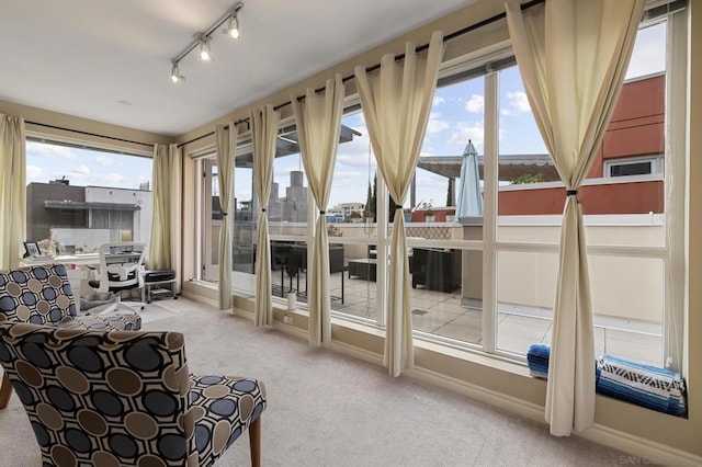 unfurnished sunroom featuring a healthy amount of sunlight and track lighting