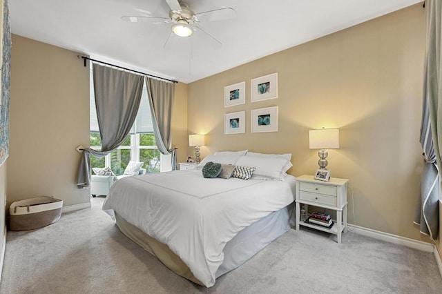 bedroom with ceiling fan and light carpet