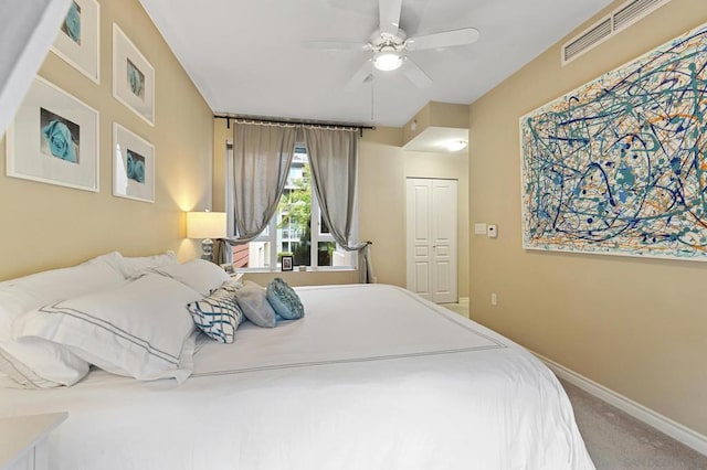 carpeted bedroom featuring ceiling fan and a closet