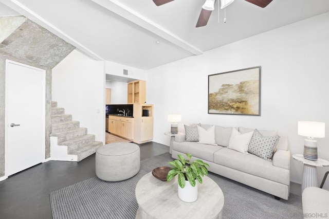 living room with beamed ceiling and sink