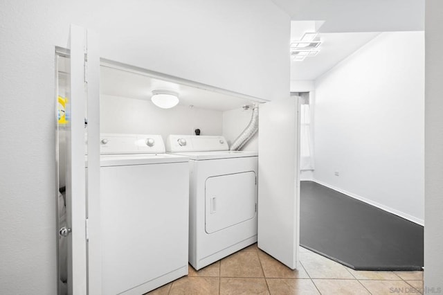 laundry room with light tile patterned floors and washer and dryer