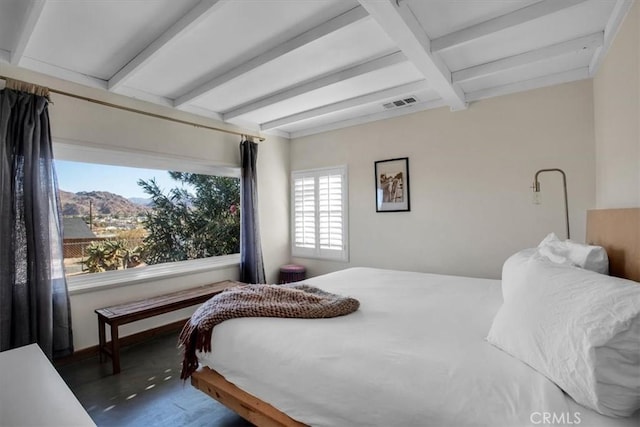 bedroom with beamed ceiling, a mountain view, and dark hardwood / wood-style flooring